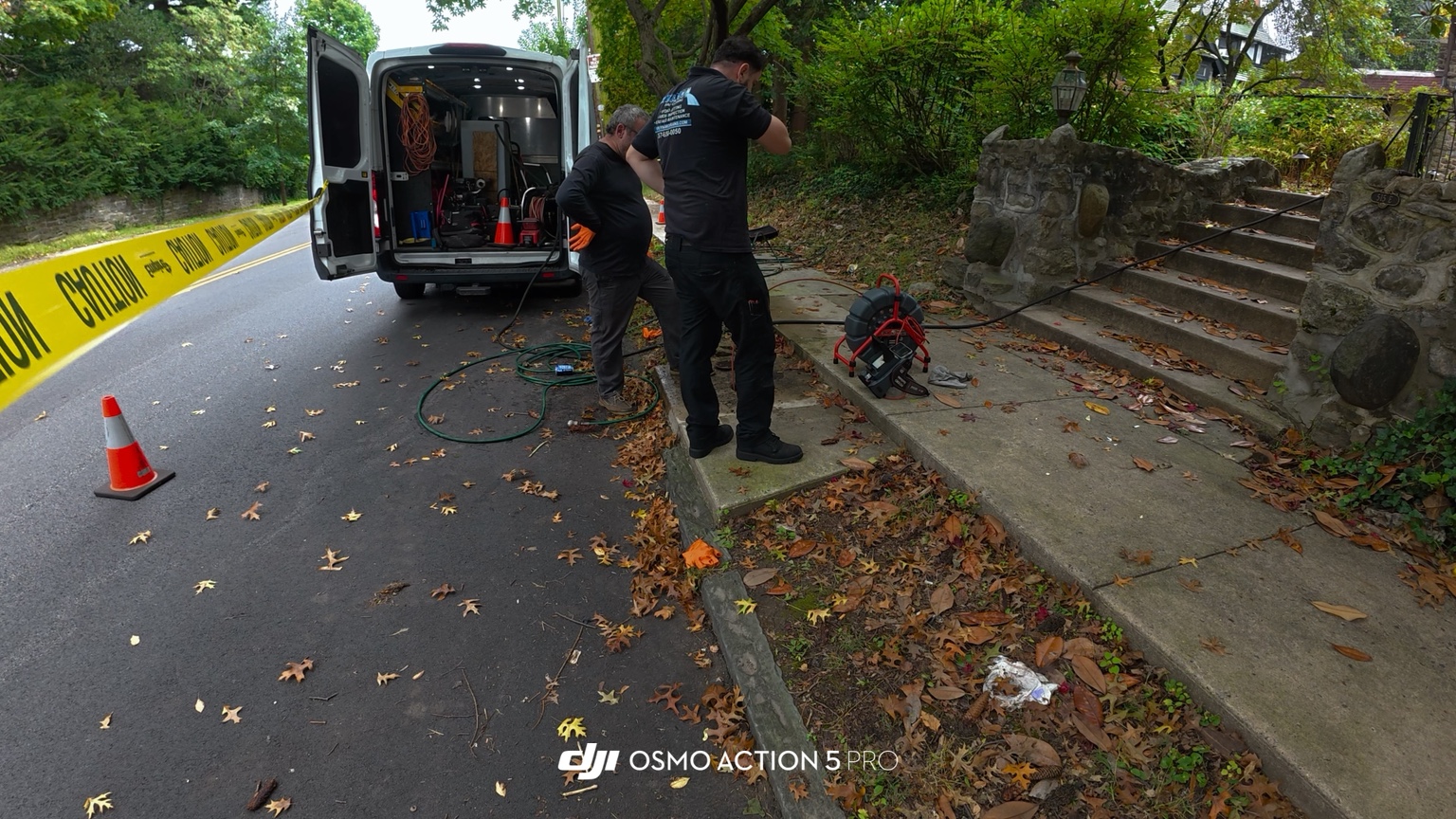 Dynamo Drains crew inspecting a sewer line from sidewalk access